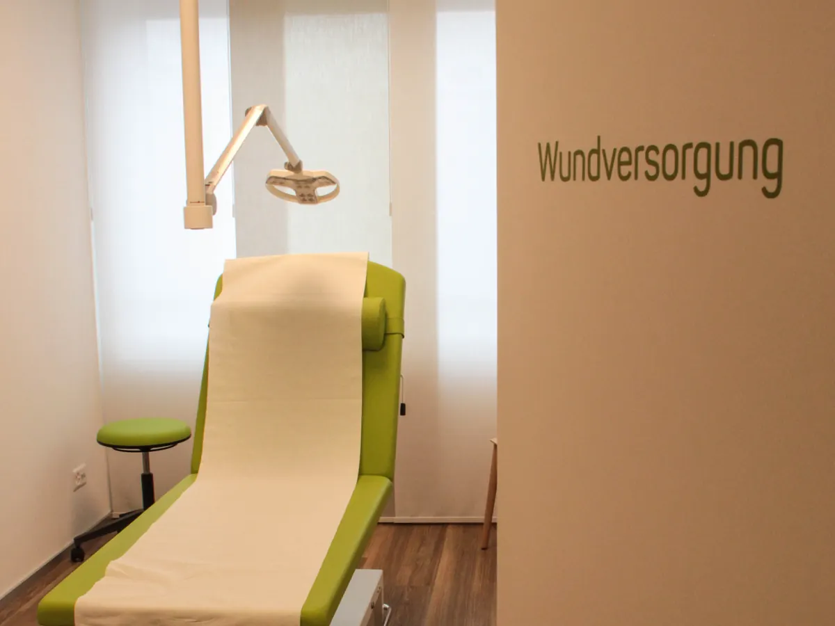 Behandlungsraum Wundversorgung mit Untersuchungsliege und Operationsleuchte